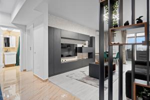 a living room with a fireplace and a tv in a room at Minimalist Green & Grey Flat in Bucharest