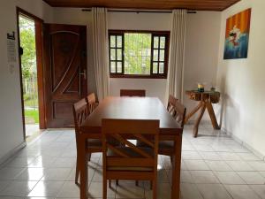 a dining room with a wooden table and chairs at Cantinho da Cerejeira in Santo Antônio do Pinhal