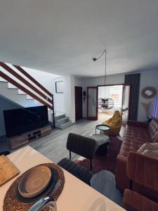 a living room with a couch and a tv at Apartment Cura in Torrevieja