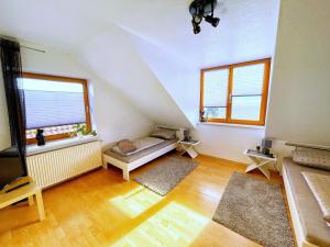 a living room with a couch and two windows at Ferienwohnung Marberth in Hildesheim