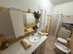 a bathroom with a sink and a toilet in it at Villa Sant Anna in Alghero +35 photos