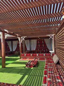 a room with red chairs and a wooden ceiling at Mangrove Camp in Sharm El Sheikh