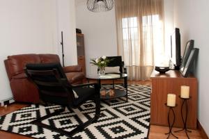 a living room with a chair and a television at Silleda Via da Plata in Silleda