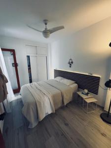 a bedroom with a bed and a ceiling fan at Apartment Cura in Torrevieja +26 photos