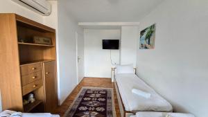 a small room with a couch and a tv at Holiday Home Old Town in Sarajevo