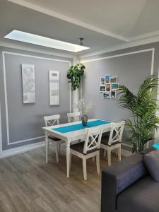 a dining room with a white table and chairs at Lago Verde Suite 25 in Puerto del Carmen