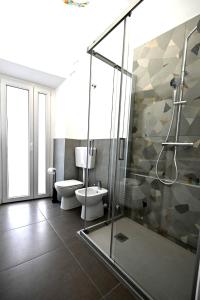 a bathroom with a glass shower and a toilet at Carta Da Zucchero in Venaria Reale
