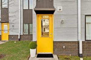 a yellow door on the side of a house at Modern Townhome 2 Miles South of Downtown and Broadway Ave in Nashville