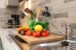 a bunch of vegetables on a cutting board on a kitchen counter at "Auszeit" in der Villa Katharina in Dierhagen