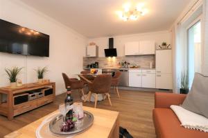 a living room with a couch and a table at "Auszeit" in der Villa Katharina in Dierhagen