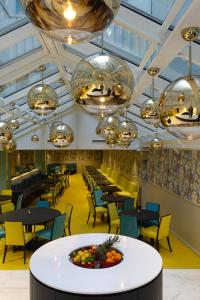 a dining room with tables and chairs and chandeliers at Thon Hotel Terminus in Oslo