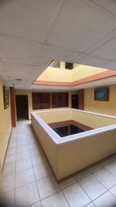 an empty hallway of a building with a large room at Parking Hotel 4 Rios in Cuenca
