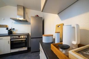 a kitchen with a stove and a refrigerator at Ferienwohnung Engelsblick in Kreuzau