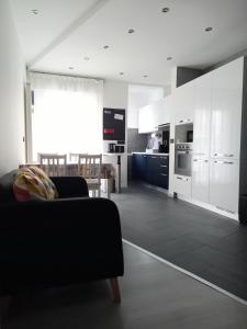 a living room with a couch and a kitchen at La Casa di Saretta in Trieste