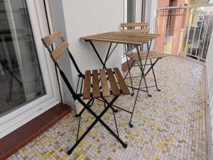 two chairs and a table on a balcony at La Casa di Saretta in Trieste