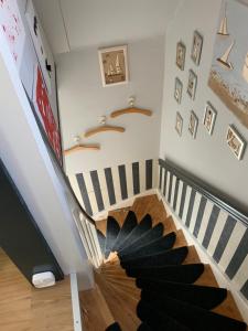 a spiral staircase in a home with a black rug at FeWo "Zwischen den Meeren" in Rendsburg