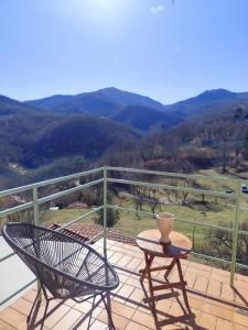 a table and chairs on a balcony with a view at Casa Louisa in Serralongue