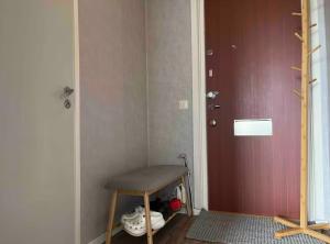 a room with a stool in front of a door at Cozy shared home for female in Stockholm in Stockholm +2 photos