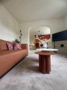 a living room with a couch and a table at Villa Haag - Design-Apartment in Fulda