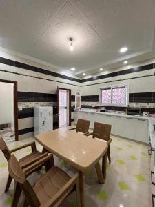 a kitchen with a table and chairs in a room at Maison Chebbi in Tozeur +2 photos