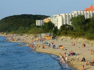 a group of people on a beach near the water at Holiday Home in Misdroy near Baltic Sea in Międzyzdroje +23 photos