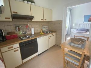 a kitchen with a sink and a stove top oven at Haus AchternDiek Strandvogel in Dahme