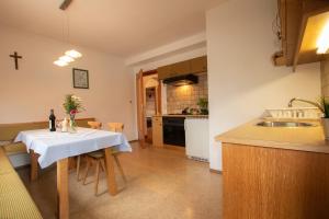 a kitchen with a table with a white table cloth at Christof,s Ferienwohnung WILD232 in Oberau
