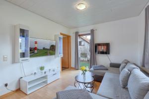 a living room with a couch and a table at Ferienhaus Zoe in Kirchheim +16 photos