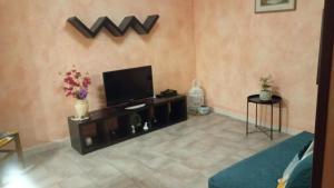 a living room with a flat screen tv on a wall at Casa Alice in Ciriè