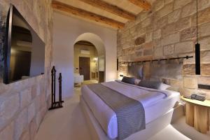 a bedroom with a large bed in a stone wall at Simurg Cave House in Urgup