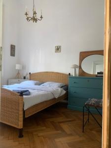 a bedroom with a bed with a blue dresser and a mirror at ANNO 1800 in Bistriţa
