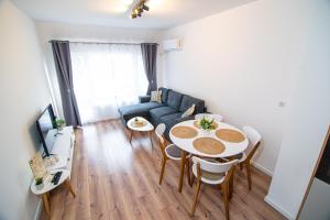 a living room with a table and a couch at Alex's Sunny Place in Stara Zagora