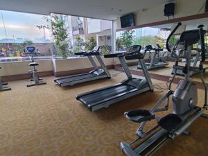 a gym with several tread machines and a large window at BCC Prime Location Vintage APT at Penuin Batam Island by MESA in Nagoya