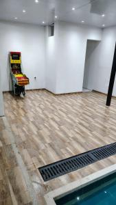 an empty room with a swimming pool and white walls at RICAURTE CASA PISCINA PRIVADA in Ricaurte +2 photos