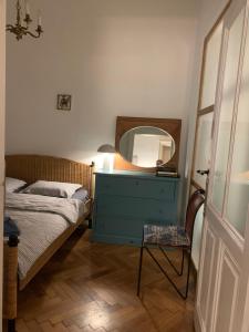 a bedroom with a bed with a blue dresser and a mirror at ANNO 1800 in Bistriţa