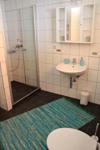 a bathroom with a toilet and a sink and a shower at Fehmarn Oase in Petersdorf auf Fehmarn +10 photos