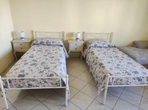 two beds sitting next to each other in a room at Luminose Camere a San Martino in Genova +6 photos