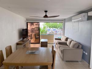 a living room with a table and a couch at Beach front paradise Rodadero in Gaira