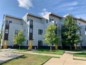 an apartment building with a bench in front of it at Modern Townhome 2 Miles South of Downtown and Broadway Ave in Nashville