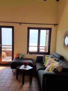 a living room with two couches and a table at "Vista dolce" in Brissago +7 photos