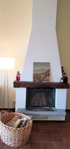 a fireplace in a room with a basket on the floor at "Vista dolce" in Brissago +7 photos