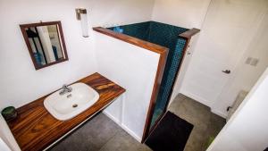 a bathroom with a sink and a mirror at Casa Del Oeste, Playa Avellanas Beach House in Playa Avellana +34 photos