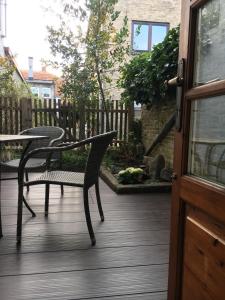a patio with a table and chairs on a deck at Alter Fischerspeicher in Eckernförde