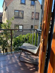 a bench sitting on a balcony with a building at Alter Fischerspeicher in Eckernförde +13 photos