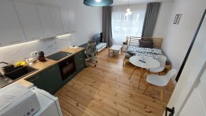 a kitchen and a living room with a table and chairs at MagMar Studio Kluczbork in Kluczbork