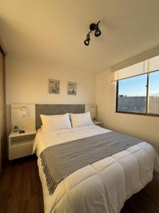 a bedroom with a large bed and a window at Caldera Apartment in Caldera +38 photos