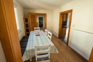 a dining room with a long table and chairs at Ferienhaus Zum Waldrand in Erfweiler
