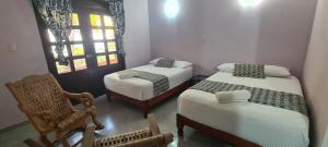 Un pat sau paturi într-o cameră la Hotel Rosa de los vientos
