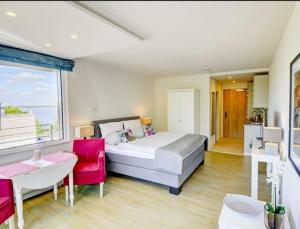a bedroom with a bed and a table and a window at Apartment Sonnendeck in Ulstrupfeld +19 photos