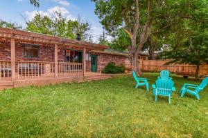 a yard with blue chairs in front of a house at Super Cute Five Bedroom Home in Denver Perfect For Girls Trips in Denver